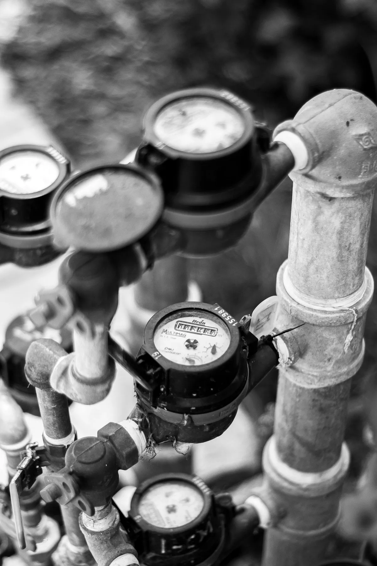 Water meters and galvanized supply piping on a manifold